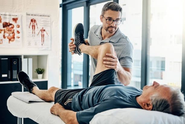 Physiotherapist performing exercise with patient